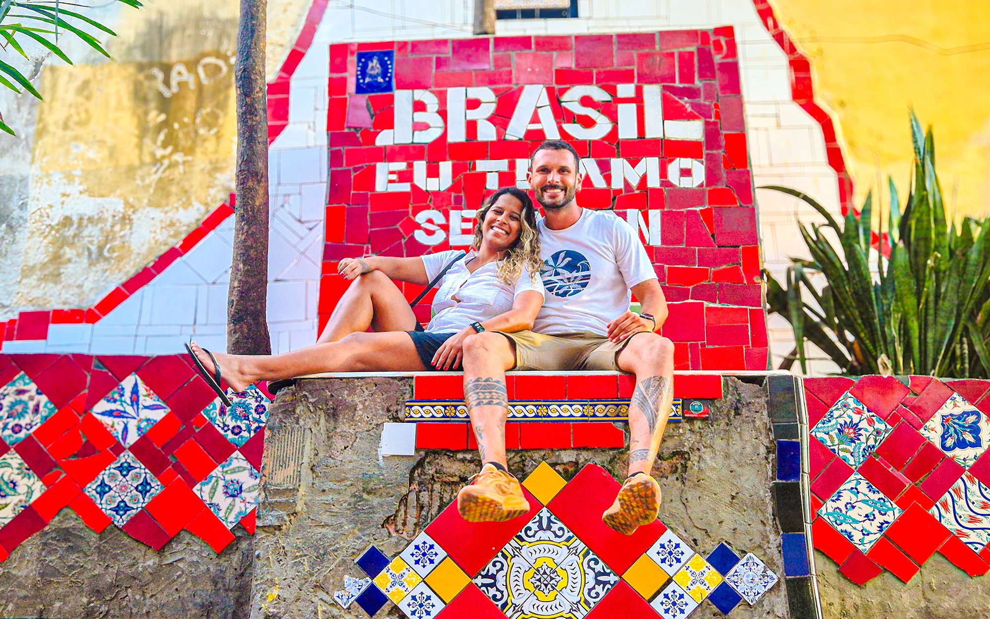 Tourists sitting on colorful Selaron Steps in Rio de Janeiro, Brazil.