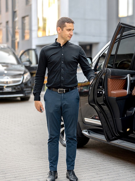 Person exiting a 4x4 vehicle during a city transfer service.