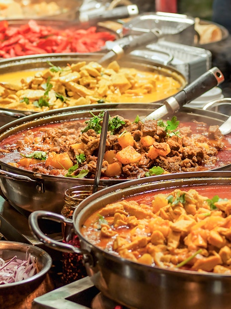 Indian buffet with various curries and dishes at KL Tower restaurant.