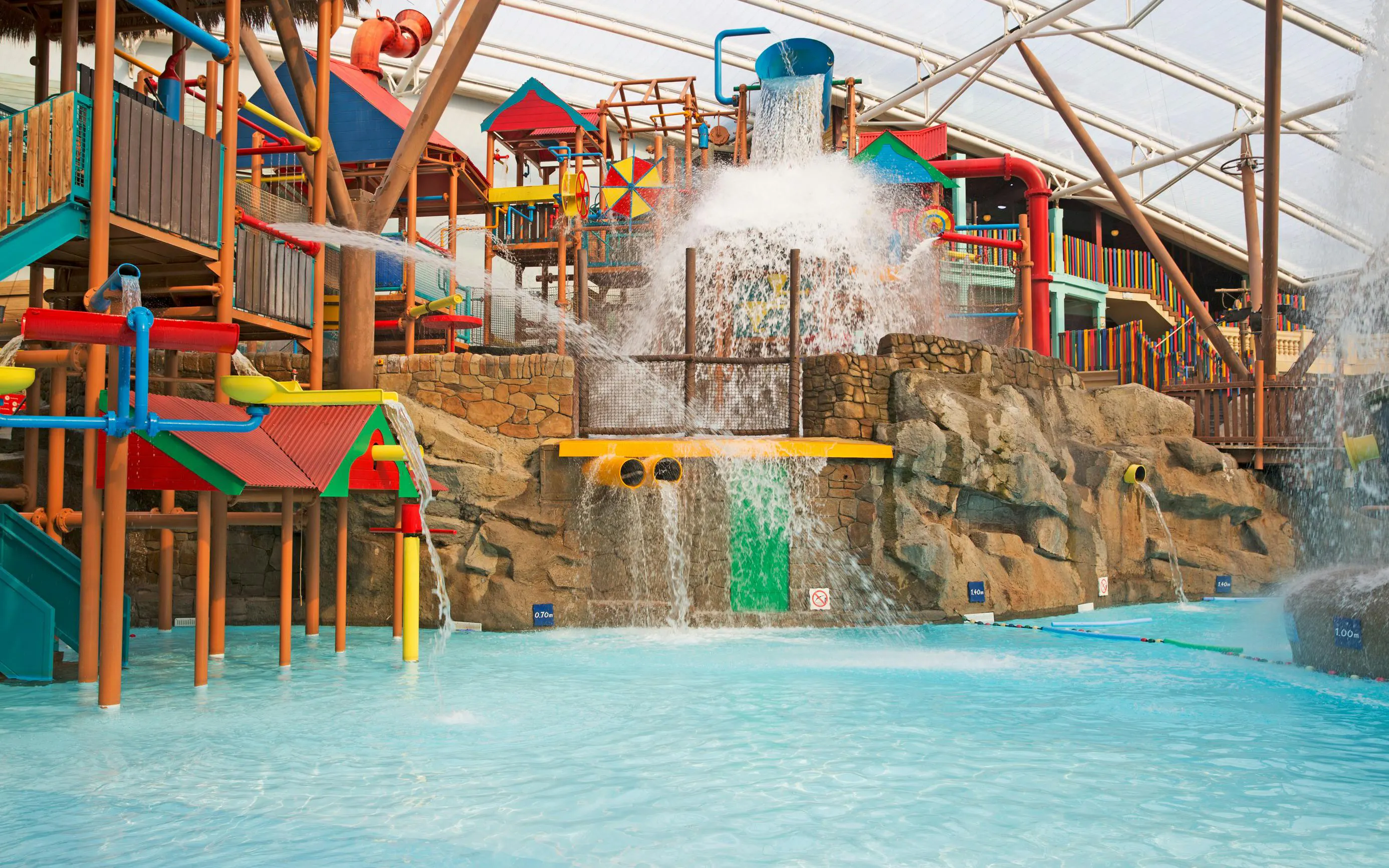 Water play area with slides and waterfalls at Alton Towers Waterpark.