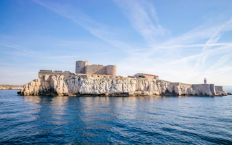 Château d'If on rocky island in Marseille, France, surrounded by blue sea.
