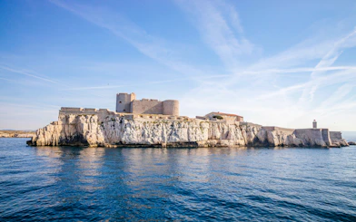 Château d'If on rocky island in Marseille, France, surrounded by blue sea.
