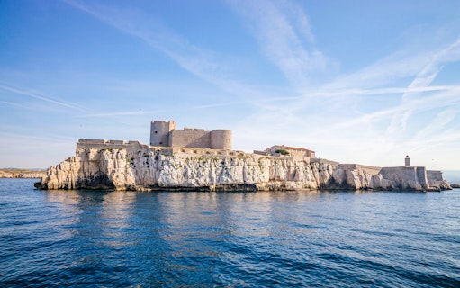 Château d'If on rocky island in Marseille, France, surrounded by blue sea.
