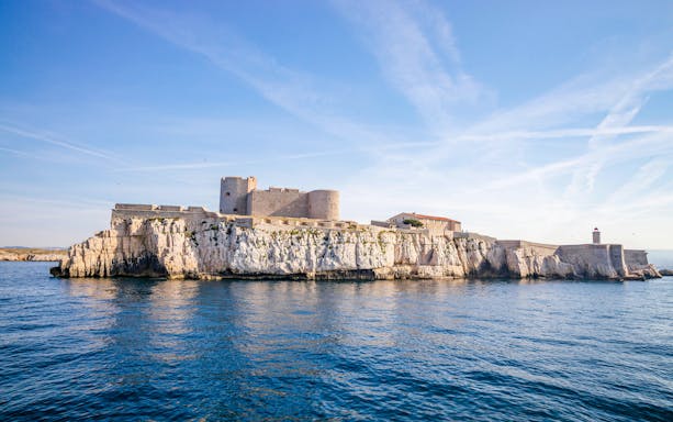 Château d'If on rocky island in Marseille, France, surrounded by blue sea.