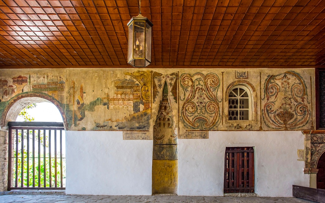 Mihrab in the portico of Bachelor's Mosque, Mangalem quarter, Berat, with intricate wall paintings.