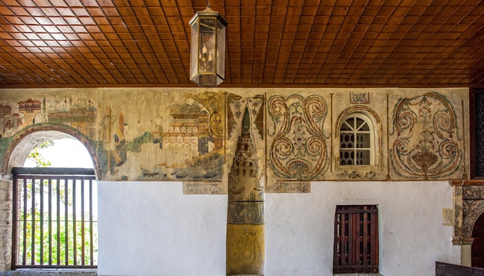 Mihrab in the portico of Bachelor's Mosque, Mangalem quarter, Berat, with intricate wall paintings.