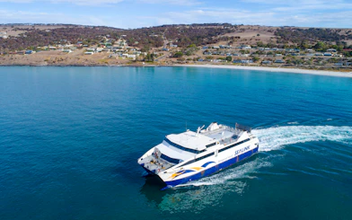 SeaLink ferry traveling from Kangaroo Island with coastal town in the background.