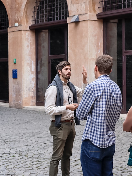Tour guide explaining history to a group at Castel Sant'Angelo, Rome.