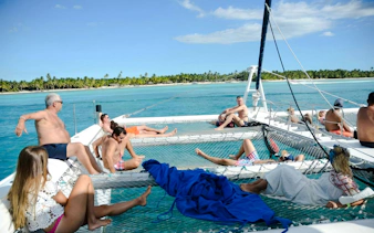 Guests relaxing on a catamaran near Saona Island, Dominican Republic.