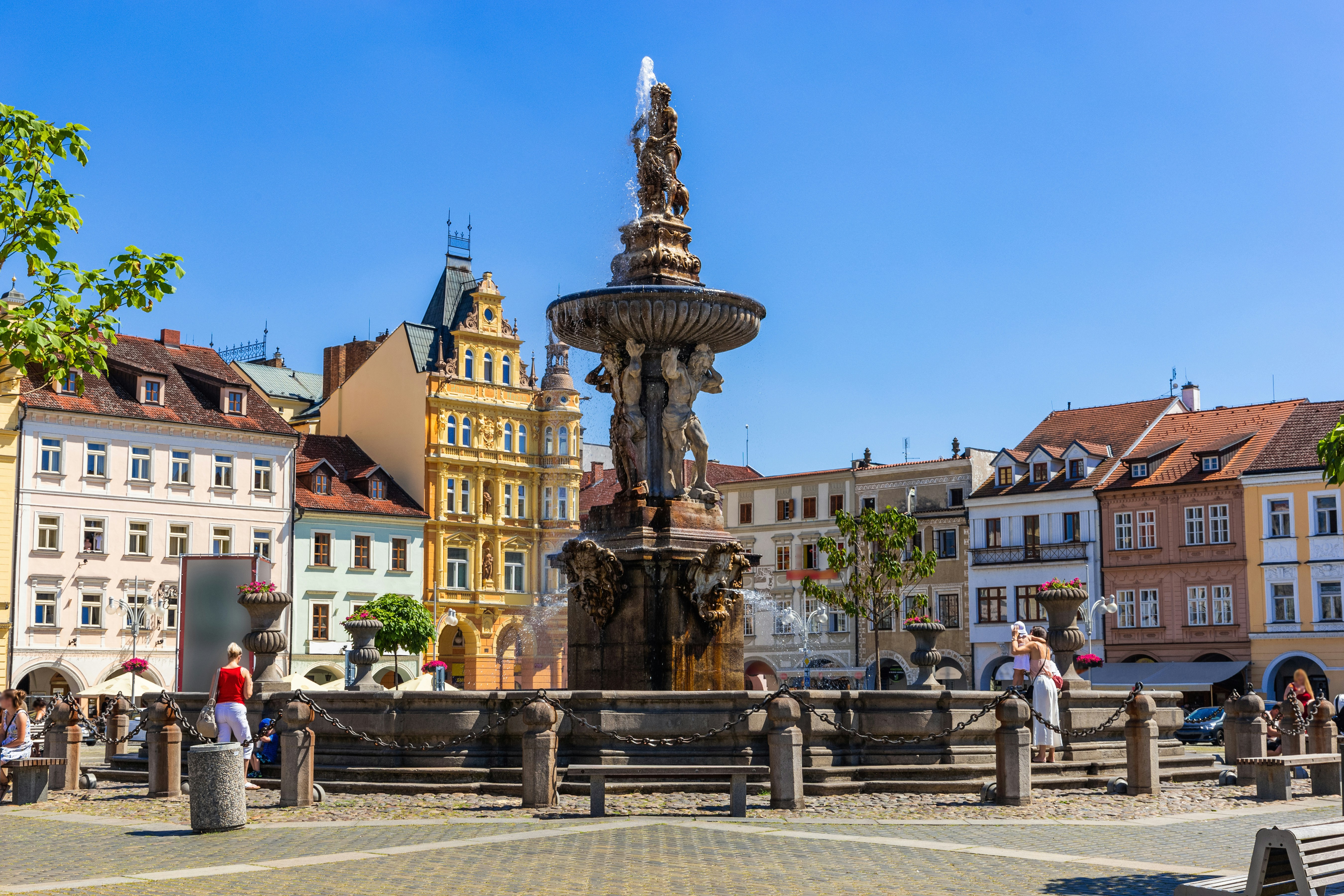 Samson fighting lion fountain and bell tower in main square, Ceske Budejovice.
