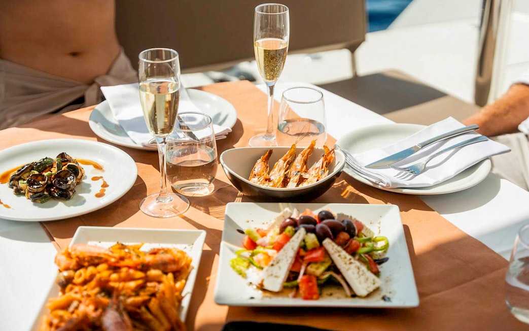 Seafood and salad meal on Santorini luxury catamaran cruise table.