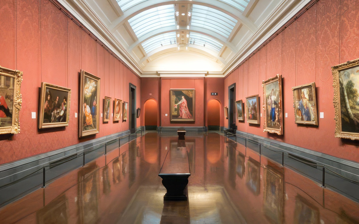 Interior of a gallery room with classic paintings at the National Gallery, London.