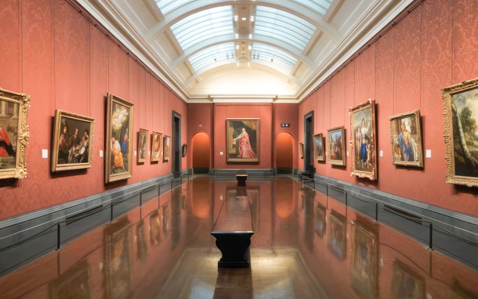 Interior of a gallery room with classic paintings at the National Gallery, London.
