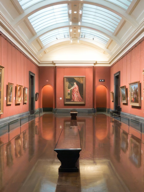 Interior of a gallery room with classic paintings at the National Gallery, London.