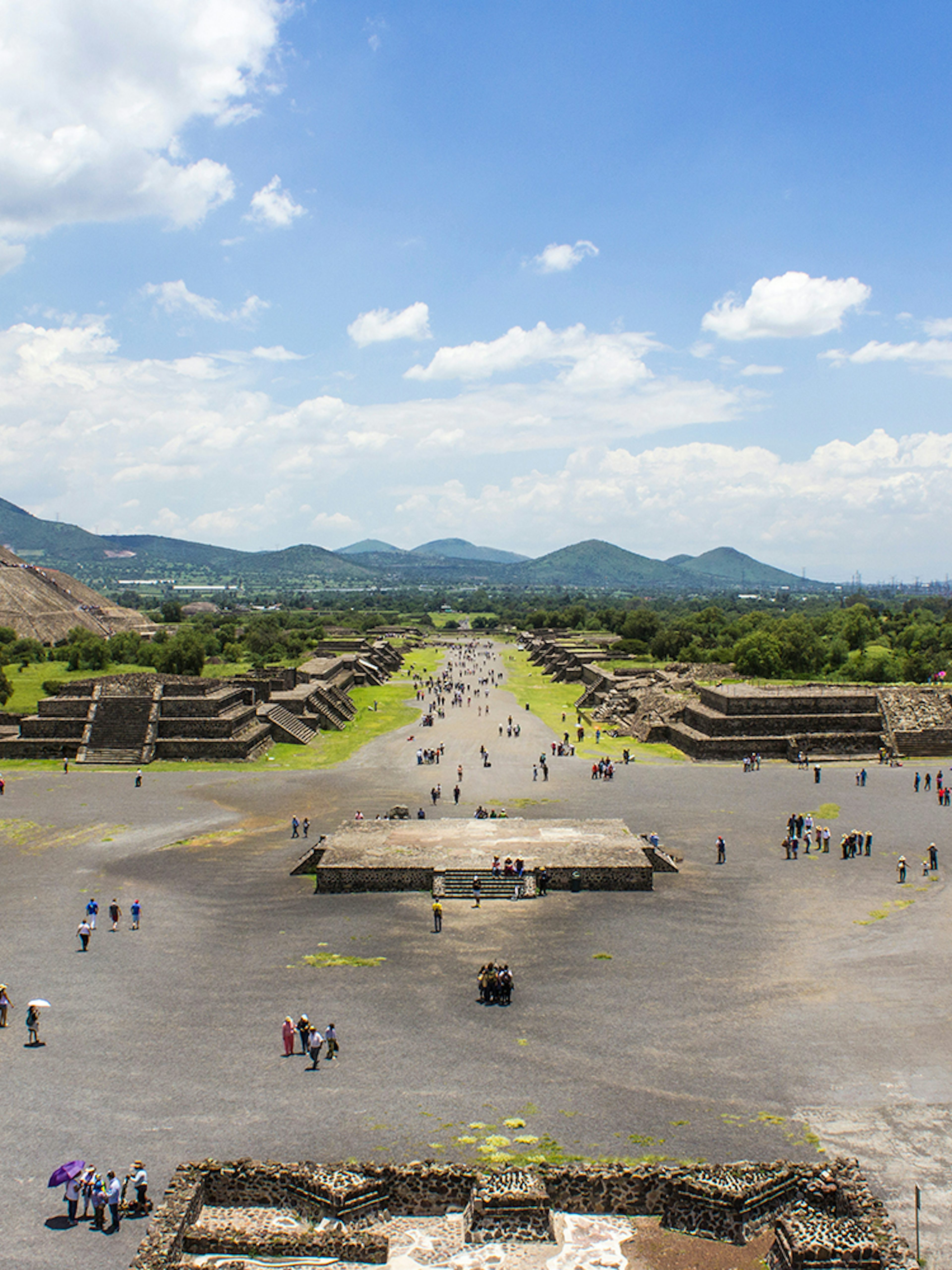 Teotihuacan pyramids and Avenue of the Dead, Mexico City, with visitors exploring.