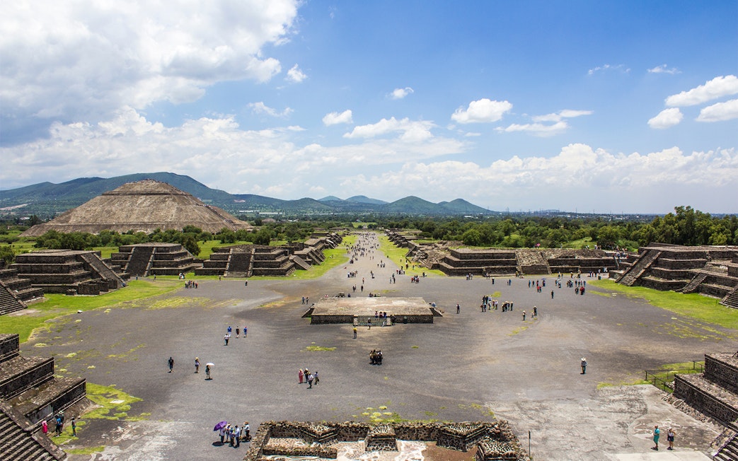Teotihuacan pyramids and Avenue of the Dead, Mexico City, with visitors exploring.