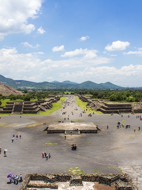 Teotihuacan pyramids and Avenue of the Dead, Mexico City, with visitors exploring.