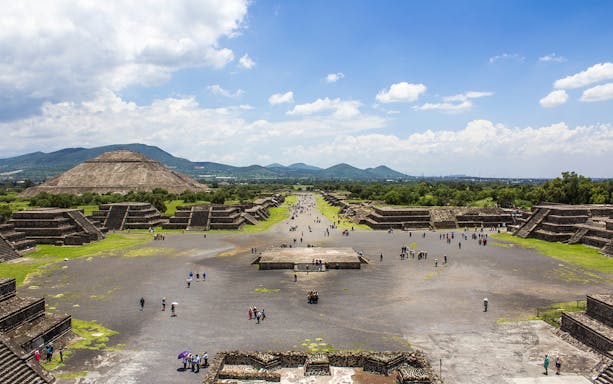 Teotihuacan pyramids and Avenue of the Dead, Mexico City, with visitors exploring.
