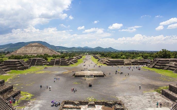Teotihuacan pyramids and Avenue of the Dead, Mexico City, with visitors exploring.