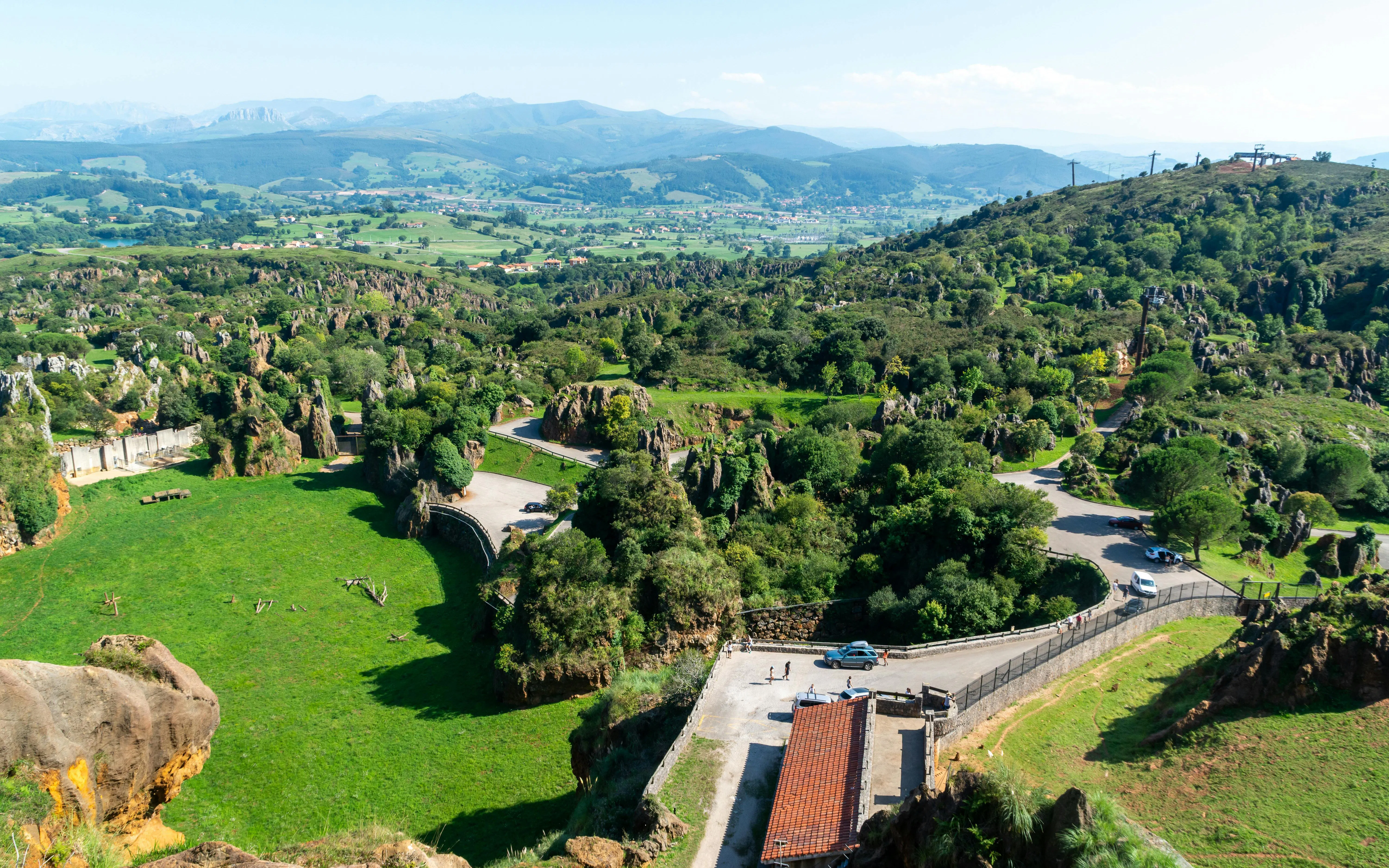 Scenic view of rocky formations and winding roads at Cabarceno Nature Park, Northern Spain.