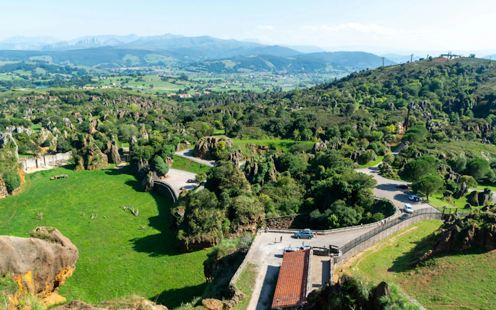 Scenic view of rocky formations and winding roads at Cabarceno Nature Park, Northern Spain.