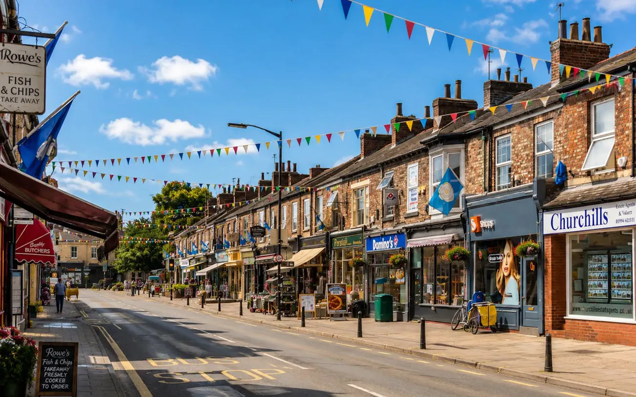 York street with shops and colorful bunting, part of the historical walking tour.