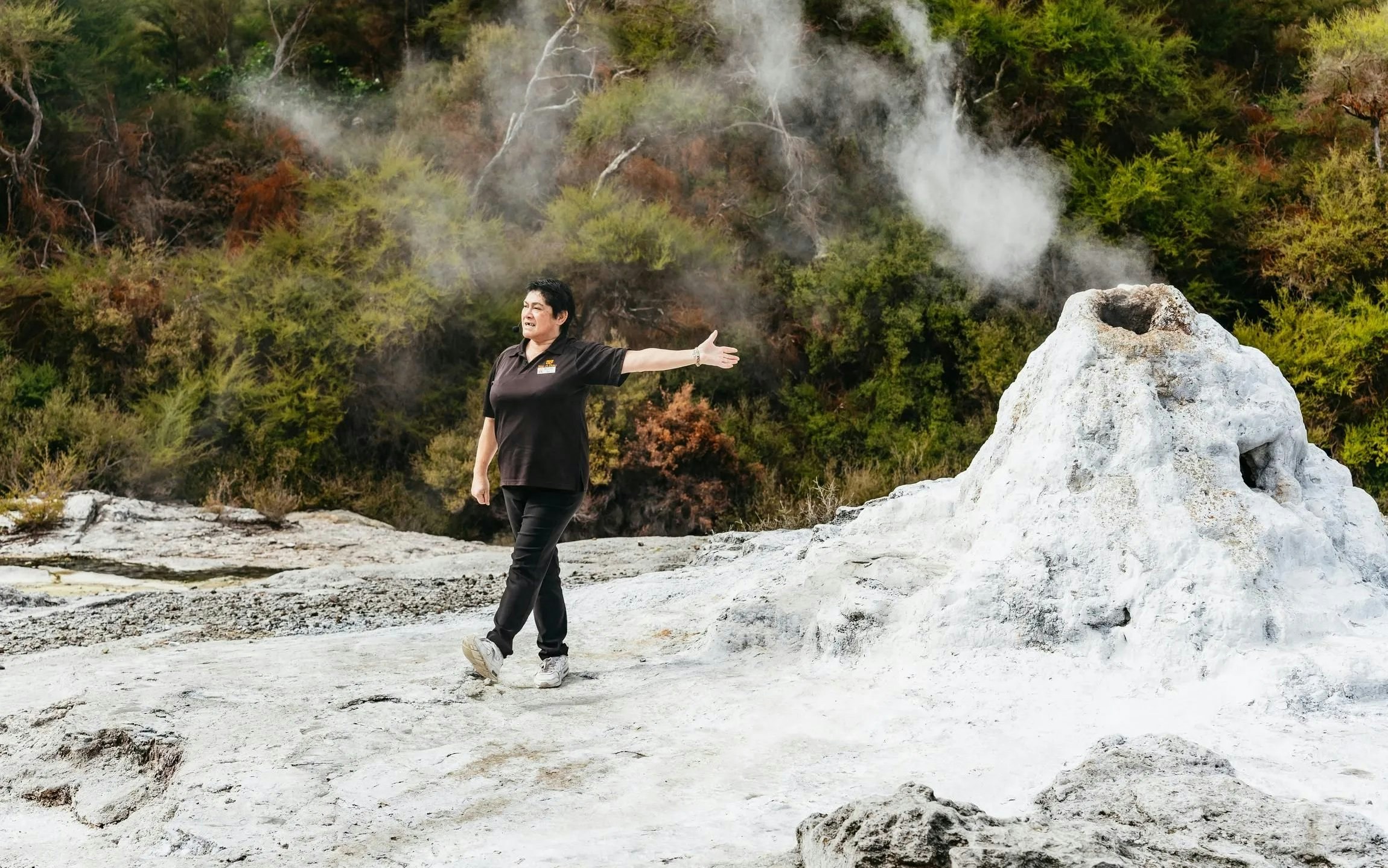Guide explaining geothermal feature at Wai-O-Tapu Thermal Wonderland, New Zealand.