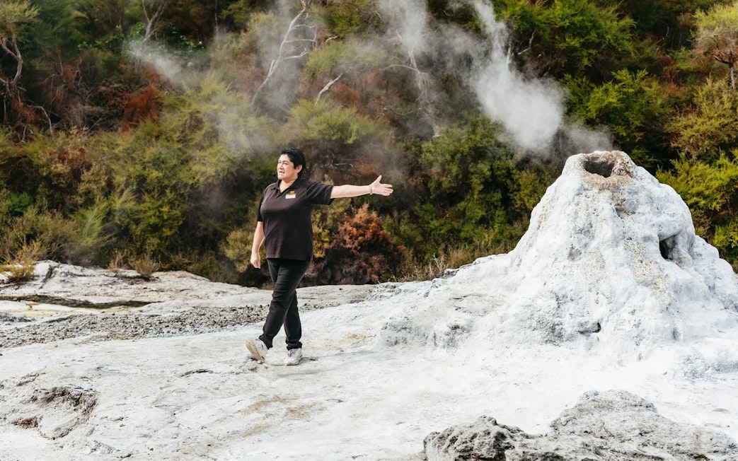 Guide explaining geothermal feature at Wai-O-Tapu Thermal Wonderland, New Zealand.