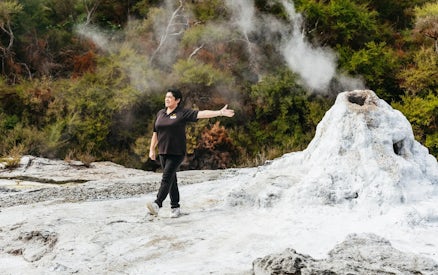 Guide explaining geothermal feature at Wai-O-Tapu Thermal Wonderland, New Zealand.
