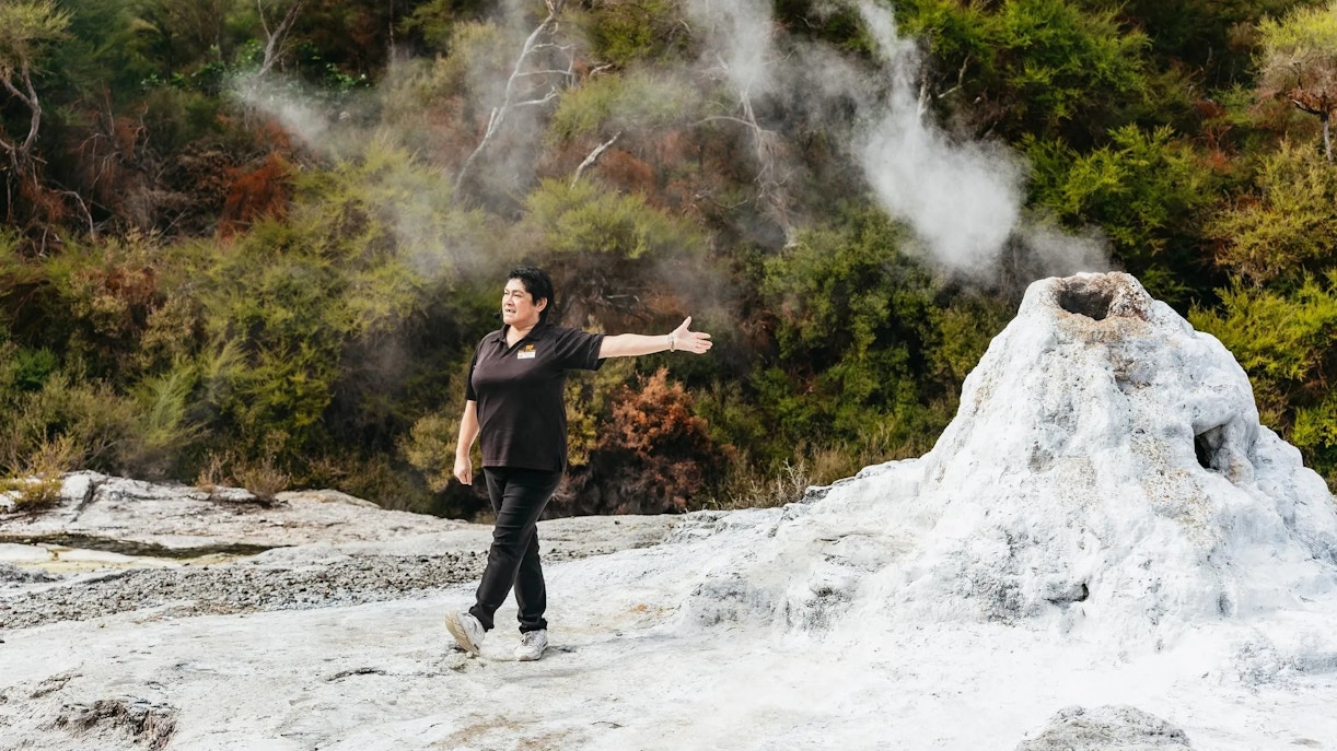 Guide explaining geothermal feature at Wai-O-Tapu Thermal Wonderland, New Zealand.