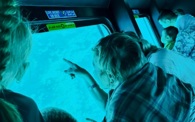 Family observing fish through submarine window on Royal Seascope, Hurghada.