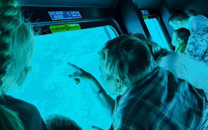 Family observing fish through submarine window on Royal Seascope, Hurghada.