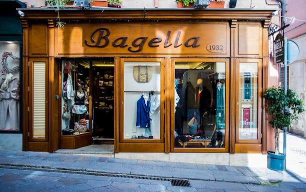 Bagella Brothers shop entrance with clothing displays in the window.