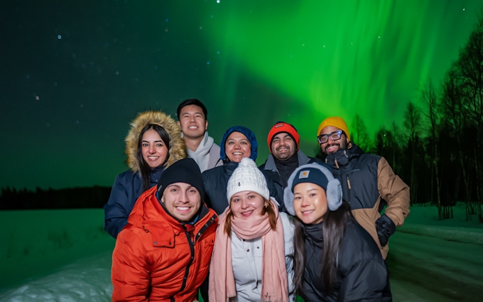 Small group watching Northern Lights in Levi, Finland.