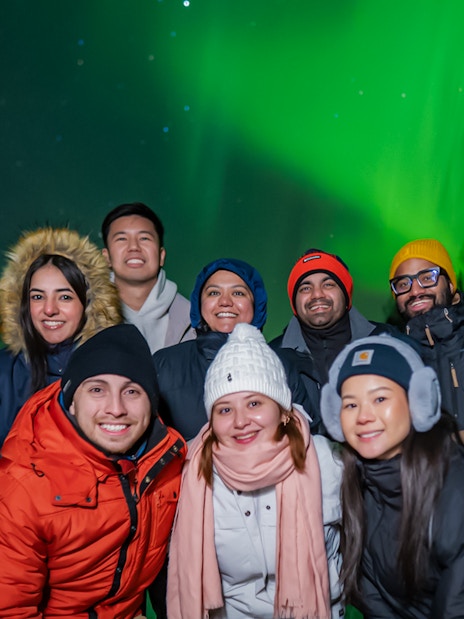 Small group watching Northern Lights in Levi, Finland.