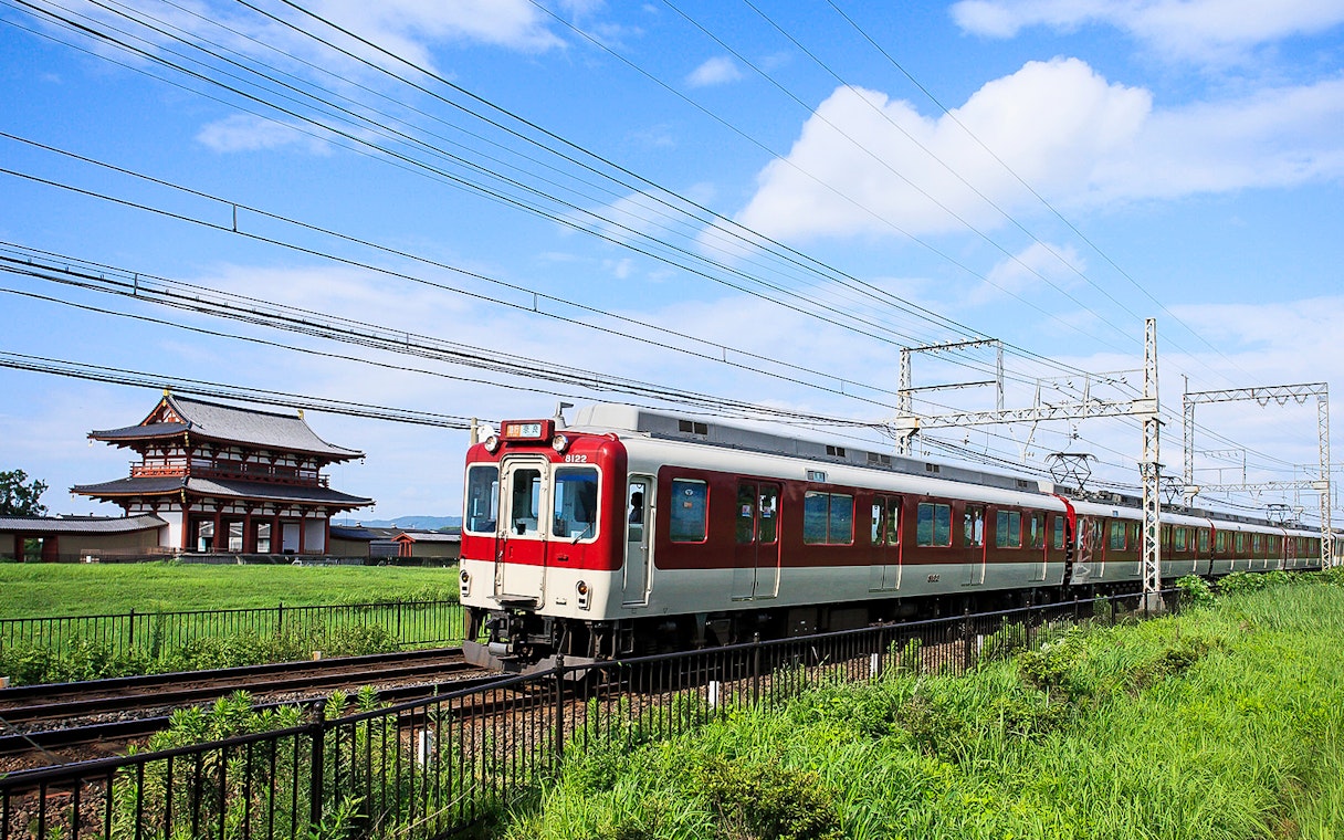 Kintetsu train passing by Heijo Palace in Nara, Japan.