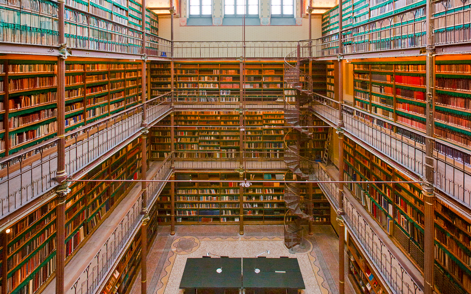 Rijksmuseum Cuypers Library interior with spiral staircase and bookshelves.