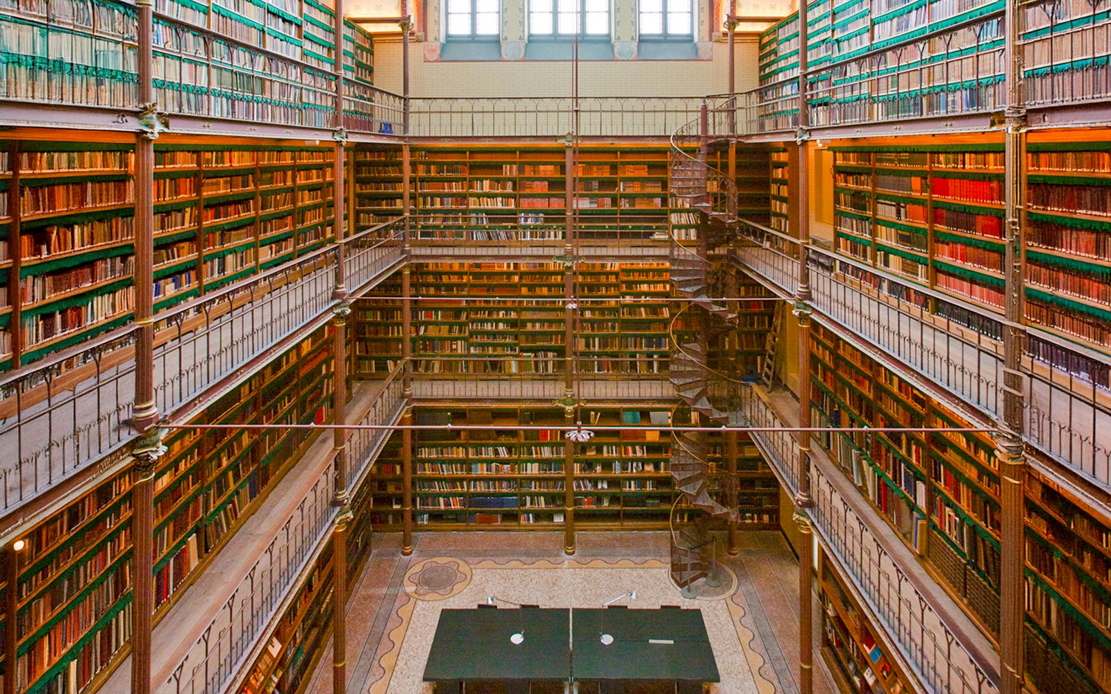 Rijksmuseum Cuypers Library interior with spiral staircase and bookshelves.