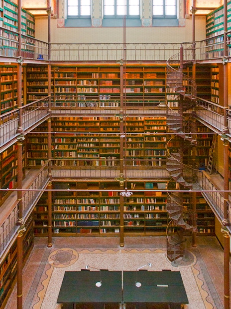 Rijksmuseum Cuypers Library interior with spiral staircase and bookshelves.