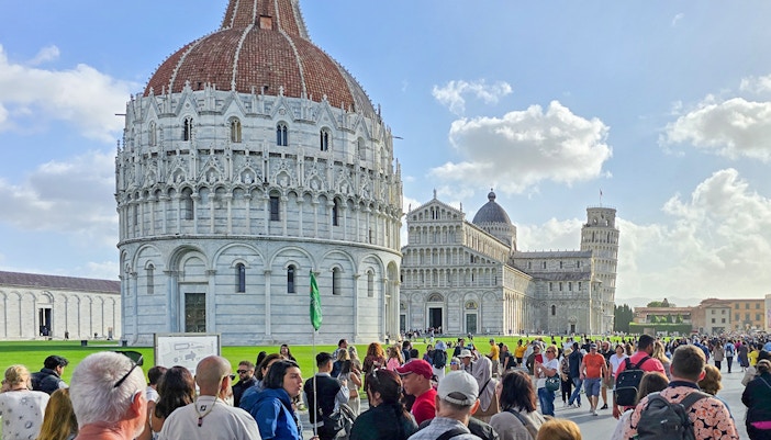 Visitors passing by the pisa baptistery on the way to the Cathedral