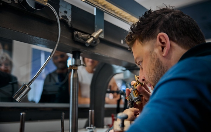 Guest examining diamond at Royal Coster Diamond Experience, Amsterdam.