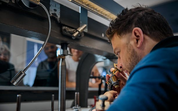 Guest examining diamond at Royal Coster Diamond Experience, Amsterdam.