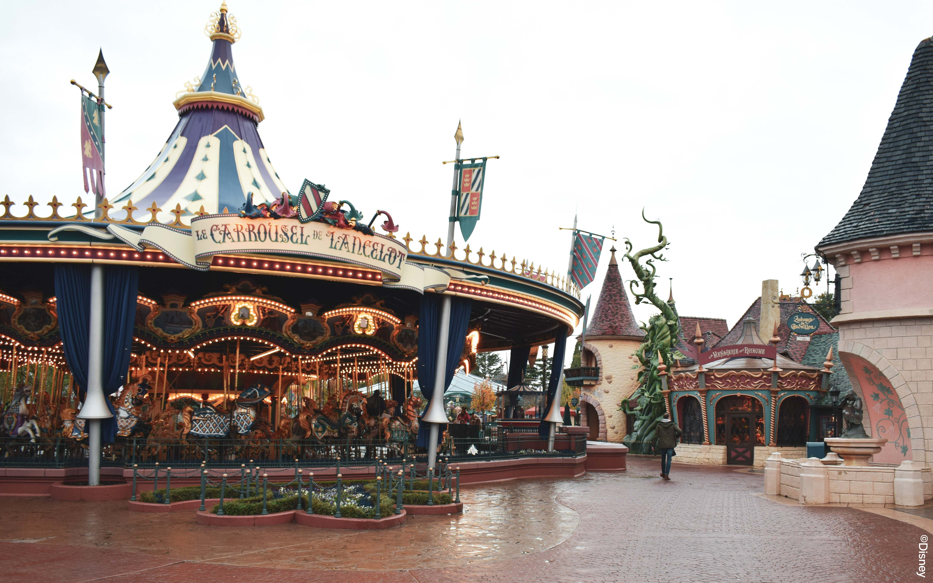 Carousel in Fantasyland, Disneyland Paris with medieval-themed decor.