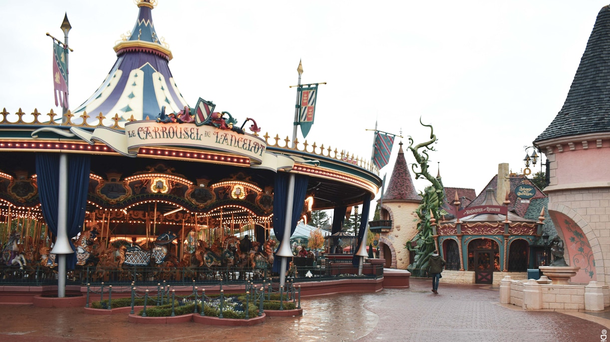 Carousel in Fantasyland, Disneyland Paris with medieval-themed decor.