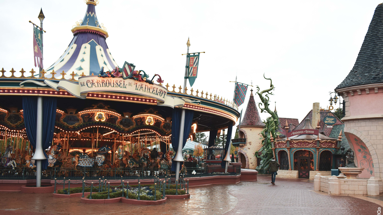 Carousel in Fantasyland, Disneyland Paris with medieval-themed decor.