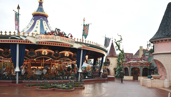 Carousel in Fantasyland, Disneyland Paris with medieval-themed decor.