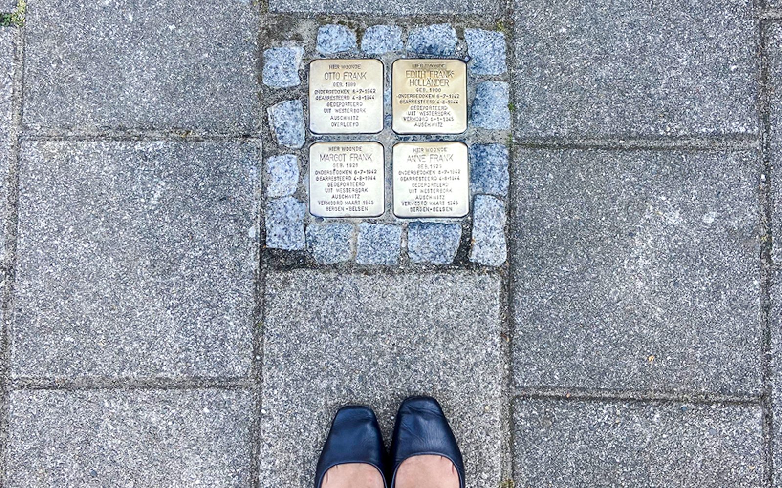 Stolpersteine memorial stones for Anne Frank's family on an Amsterdam street.