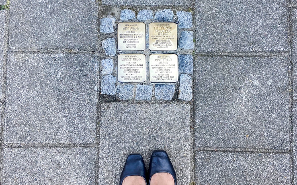 Stolpersteine memorial stones for Anne Frank's family on an Amsterdam street.