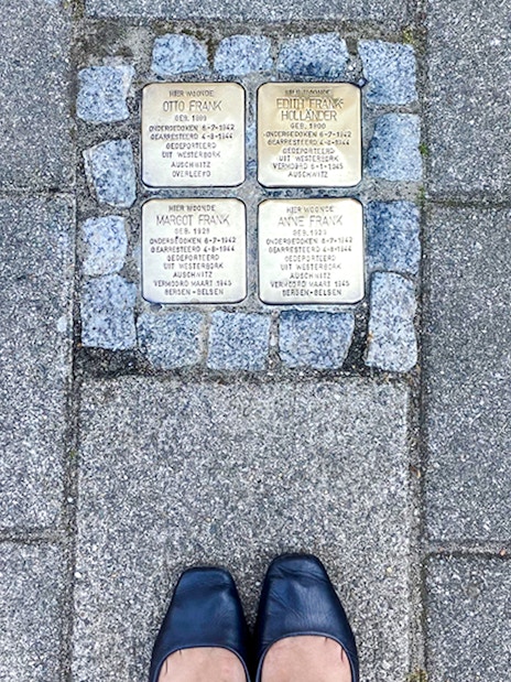 Stolpersteine memorial stones for Anne Frank's family on an Amsterdam street.