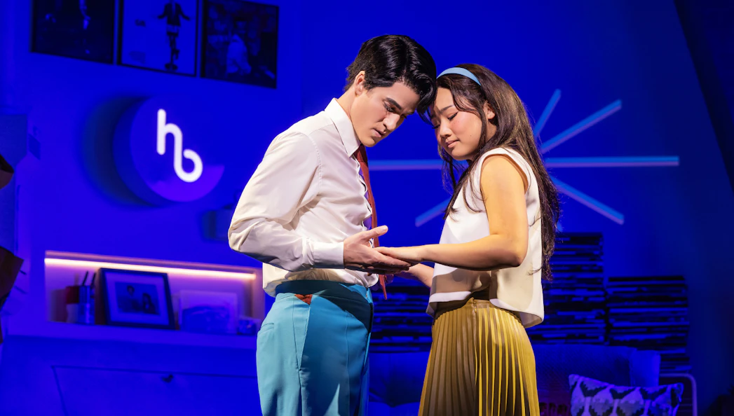 Two actors in an intimate moment on stage during "Maybe Happy Ending" performance.